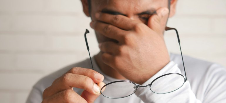 a person holding their head in pain.