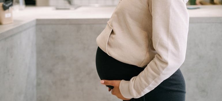 Pregnant woman in a sleeveless top.