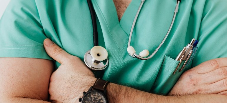 The doctor stands with crossed arms and can diagnose prostate cancer