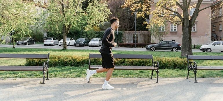 A man running in the park, thinking about how physical activity helps manage type 2 diabetes.