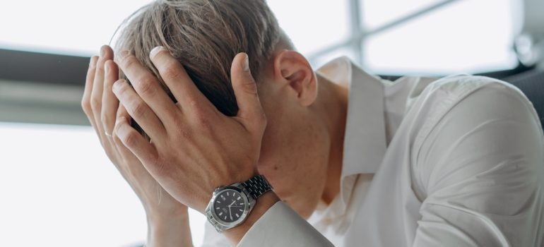 A person holding their head in exhaustion