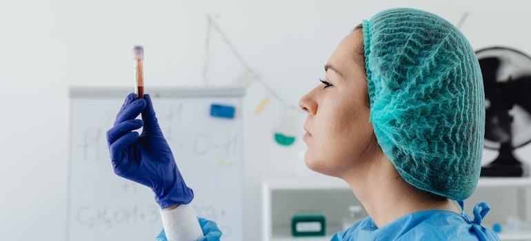 A doctor is holding a blood sample.