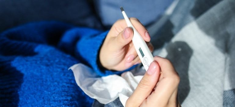 A person holding a thermometer